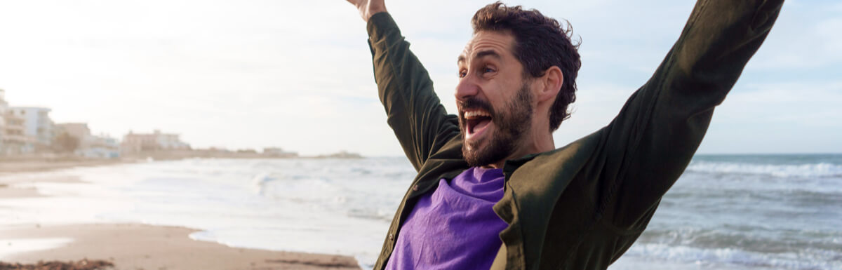 Man celebrating with arms in air