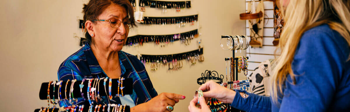 Native American shop owner with customer