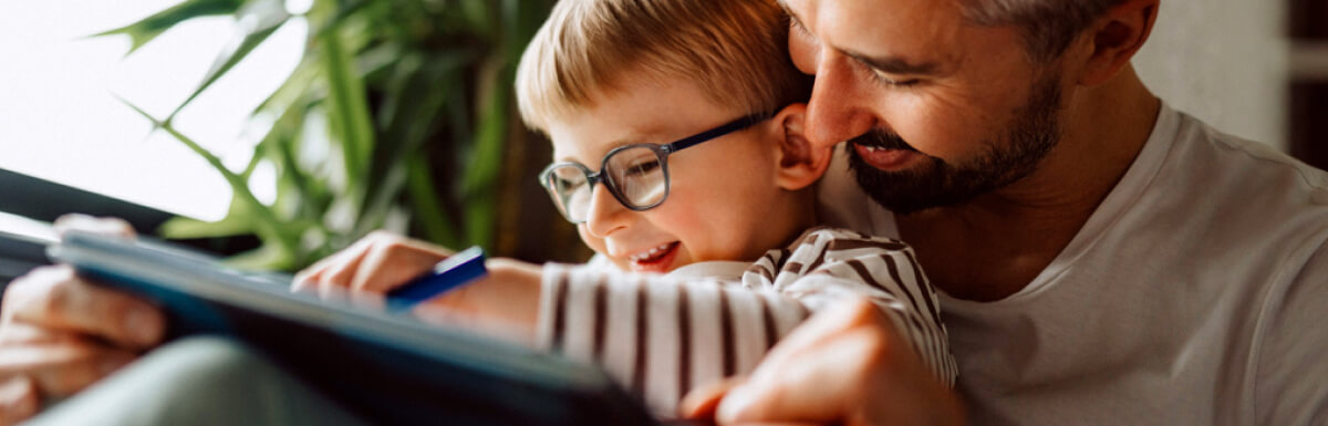 Smiling man with little son in lap