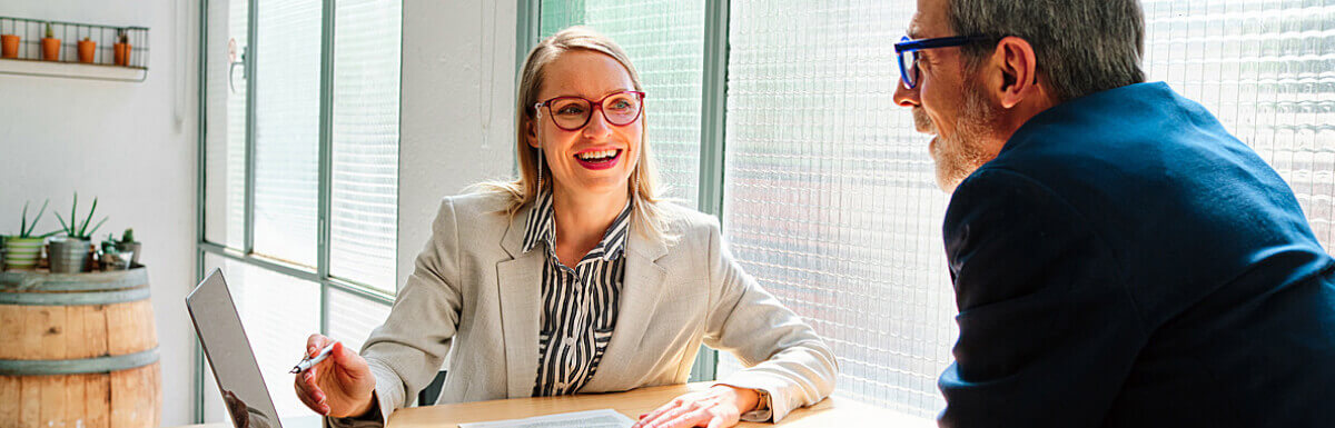Female insurance agent helping  client at desk