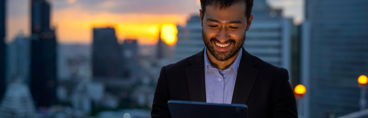 businessman with tablet in cityscape