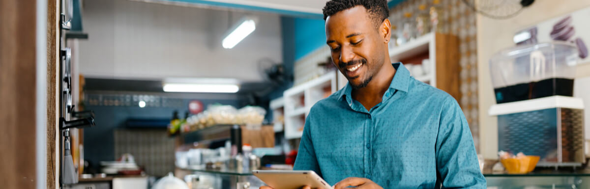 Small business owner in shop with tablet
