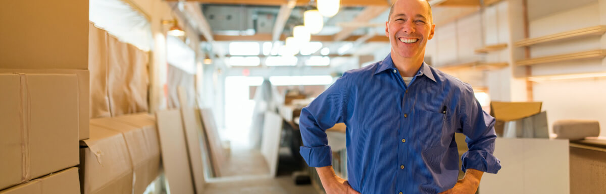 Smiling businessman in warehouse