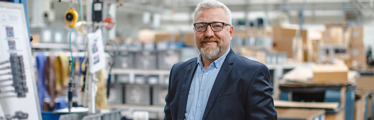 business man standing in factory