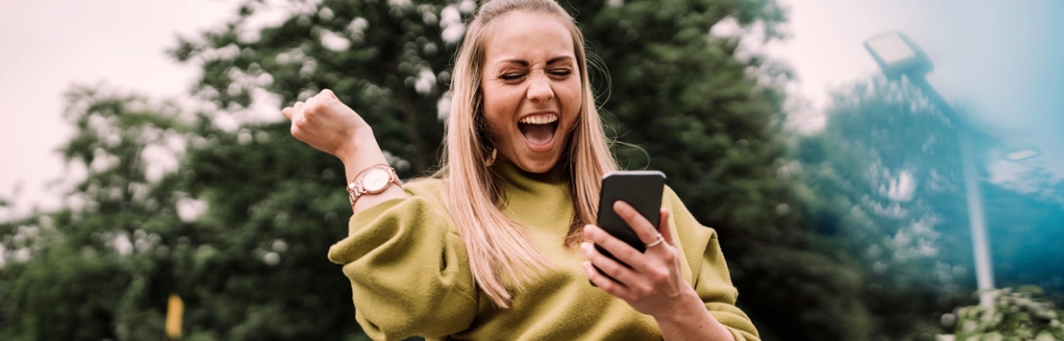Excited woman with mobile phone