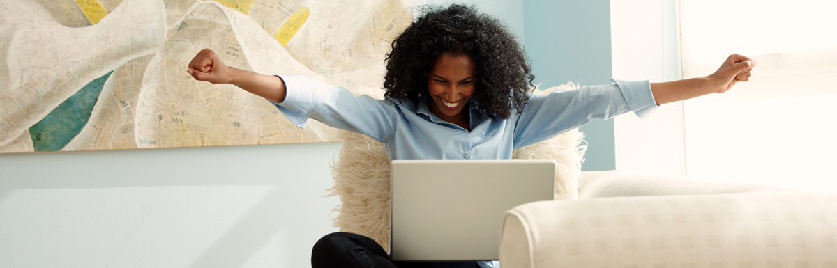 Woman happy looking at laptop