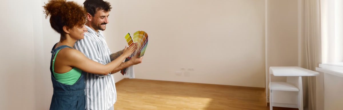 couple in room looking at paint swatches